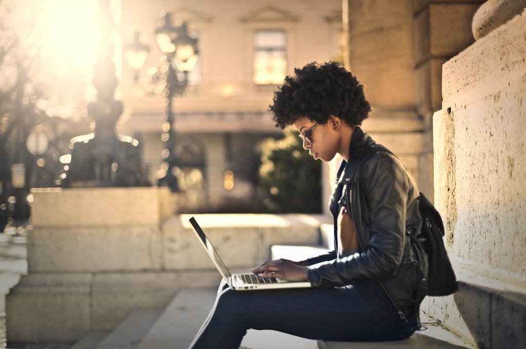 Woman sitting outside on her laptop