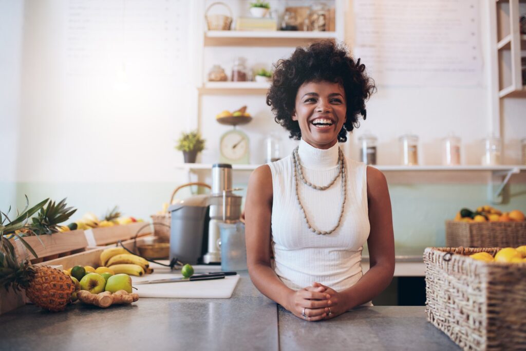 woman who owns a local business smiling