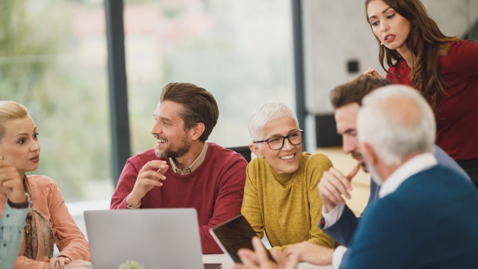 Marketing team reviewing results together around a conference table