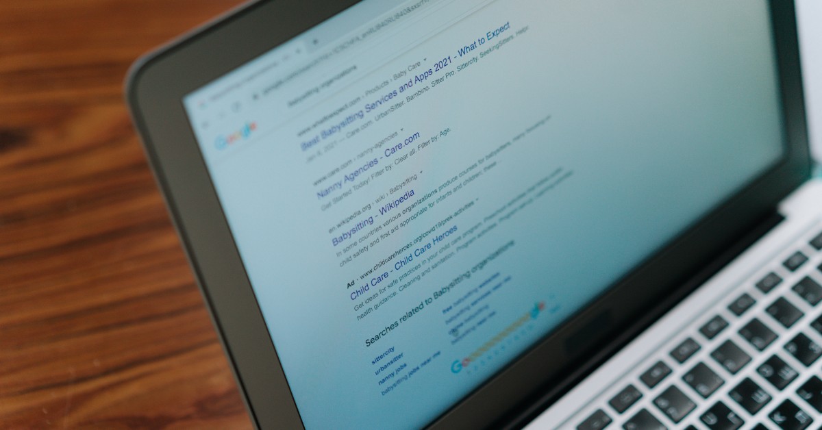 Laptop showing a Google search results page with paid ads above the organic listings