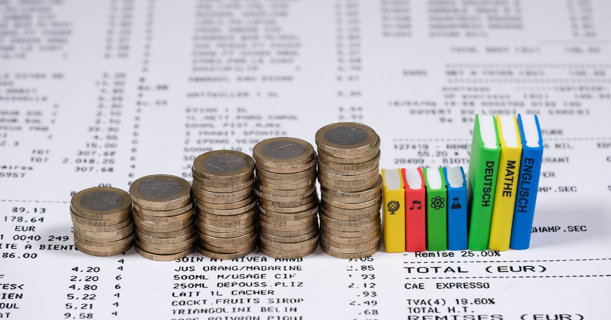 Rising stacks of coins on a printed receipt, representing cost per click adding up