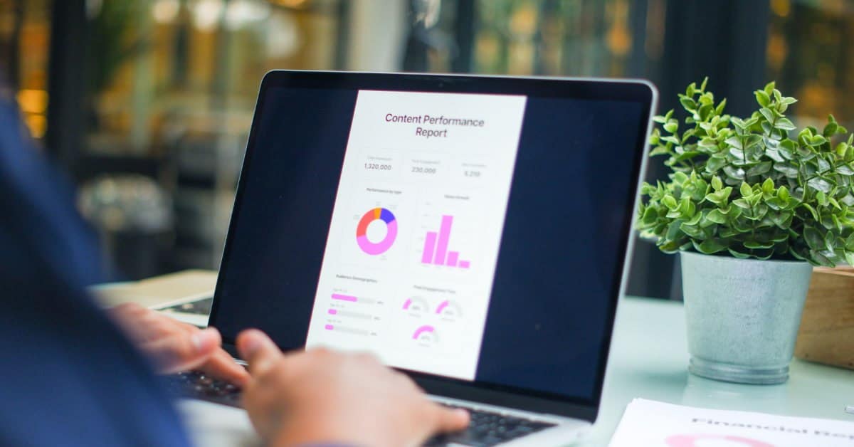 Laptop displaying a content performance report with traffic and conversion charts