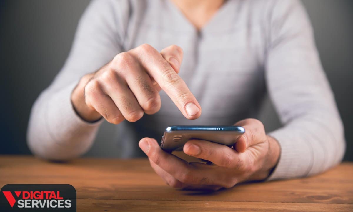 A person tapping the screen of a smartphone held in one hand