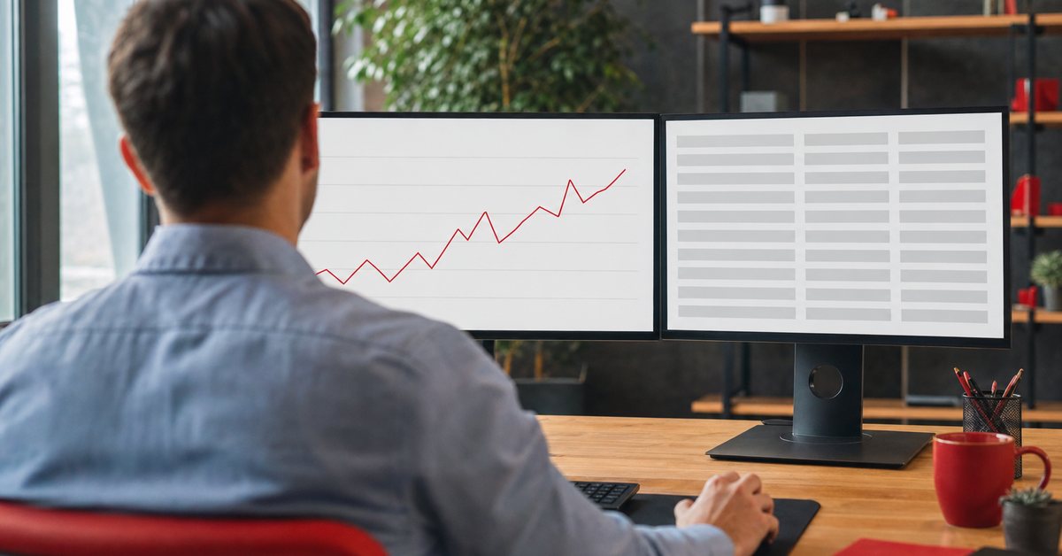 An analyst comparing search performance charts across two monitors